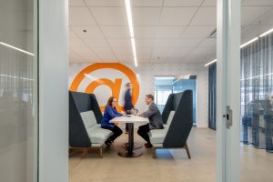 Photo of a two people in a collaborative space in Schermer's offices.