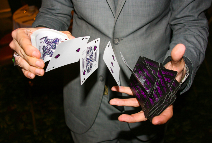 Magician shuffling cards in mid air