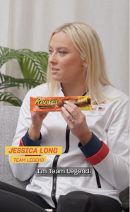 Woman holding Reese's candy bar.