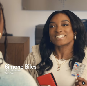 Simone Biles holding Visa card