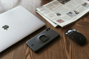 Laptop, phone and newspaper photo.