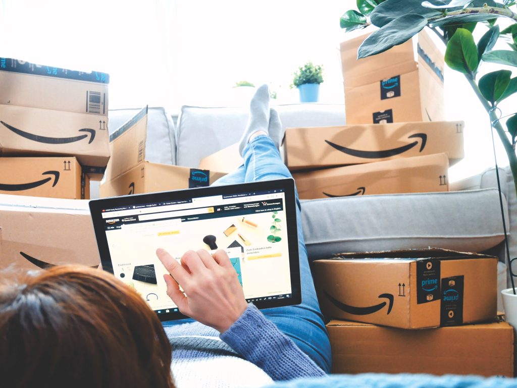 online shopping with amazon packages in background